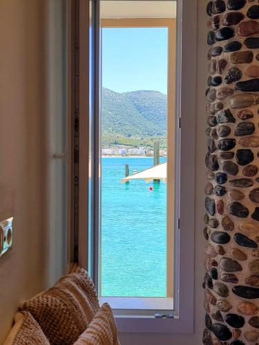 a window with a view of the water at Artis Blue Relax in Himare