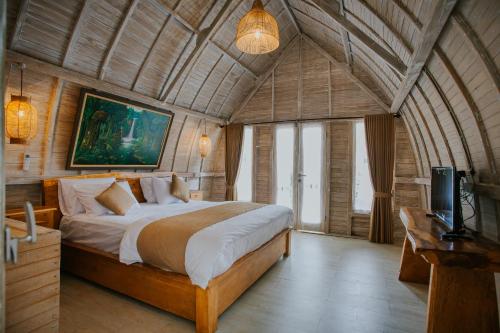 a bedroom with a bed and a television in it at Wage cottage in Nusa Penida