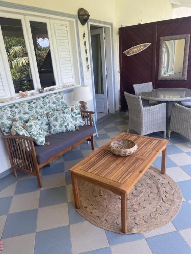 a living room with a couch and a coffee table at La Valentine Résidence La Plantation Sainte Marthe in Saint-François