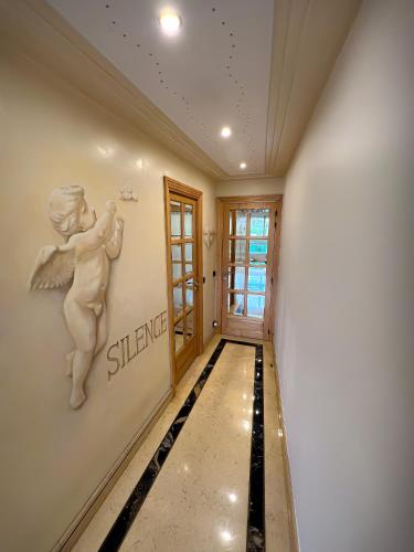a hallway with a painting of a child on the wall at Les Amoureux de Paris in Paris