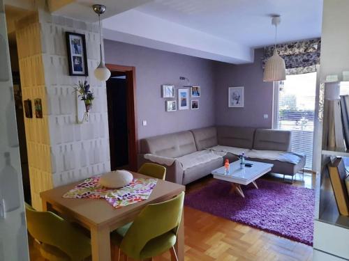 a living room with a table and a couch at Sweet Cozy Apartment in Skopje
