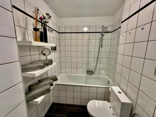 Atemberaubender Rheinblick Messe في دوسلدورف: حمام أبيض مع حوض ومرحاض