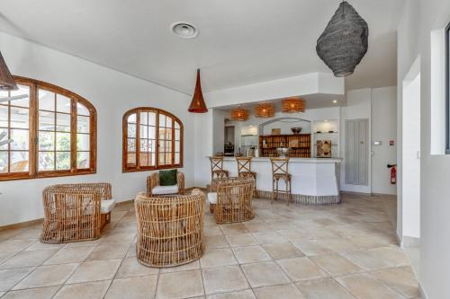 un soggiorno con sedie in vimini e una cucina di La Garoupe-Gardiole a Antibes