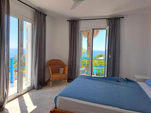 a bedroom with a bed and a view of the ocean at Villa Emilios in Lakhanádha
