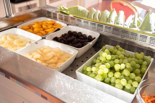 a refrigerator filled with different types of fruits at Hotel Santa Gilla in Capoterra