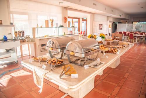 a long table with food on it in a room at Hotel Santa Gilla in Capoterra