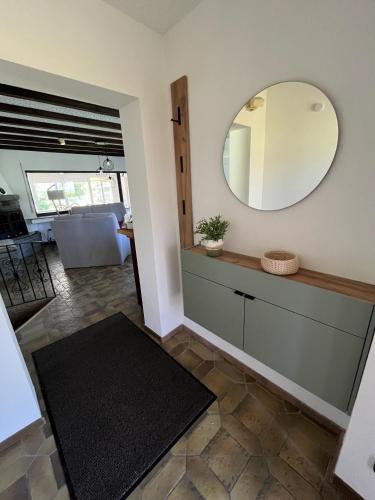 a living room with a mirror on the wall at EifelSeensucht in Heimbach