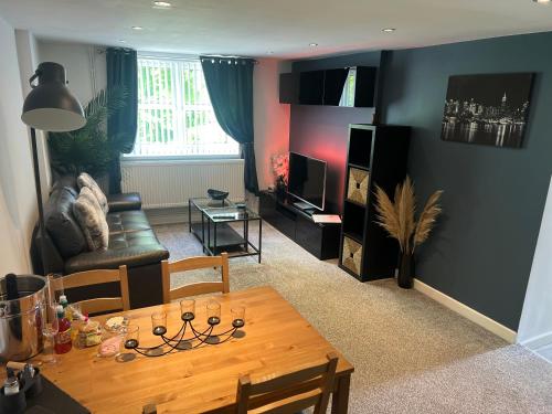a living room with a table and a couch at Ty Daisy, Gilwern in Gilwern