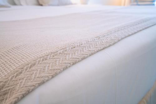 a close up of a bed with a white mattress at Hotel Santa Gilla in Capoterra