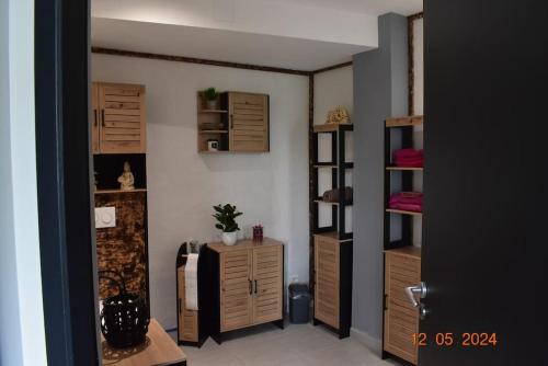 Cette chambre dispose d'armoires en bois et d'un réfrigérateur. dans l'établissement Charmant RDC au Cœur du village, à Soual