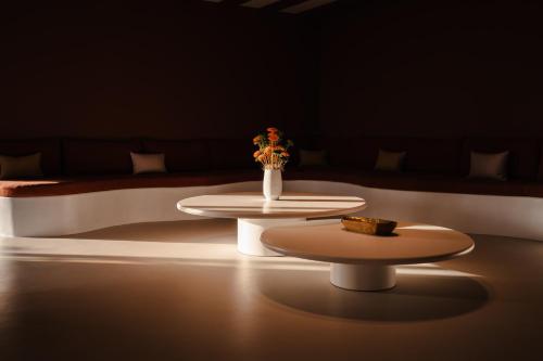 two tables in a dark room with a couch at Croco Mykonos in Tourlos
