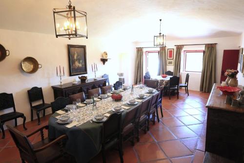 a large dining room with a long table and chairs at Country House and Estate - Herdade da Azinheira in Pavia