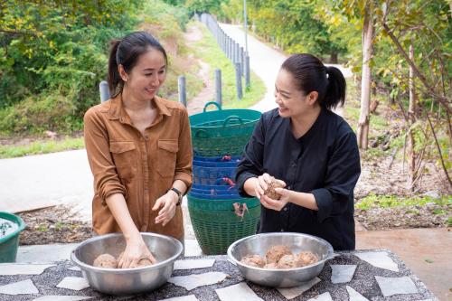 two women standing around a table preparing food at Sheraton Hua Hin Resort & Spa in Cha Am