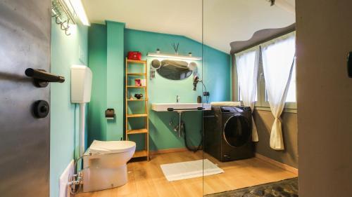 a bathroom with a toilet and a sink and a mirror at Flytosuite it con 35 Camere 3 Suite Delux in Calderara di Reno
