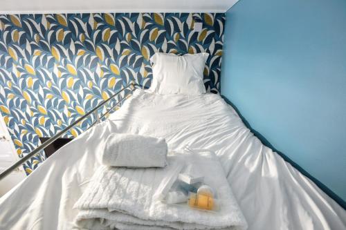 - un lit avec 2 serviettes et 2 bougies dans l'établissement 548 Suite Dulac - Superbe Appartement à Paris, à Paris