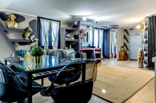 a dining room with a glass table and chairs at Flytosuite it con 35 Camere 3 Suite Delux in Calderara di Reno