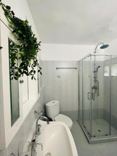 a bathroom with a toilet and a sink and a shower at Green House - Central Stay in Plomari in Plomari
