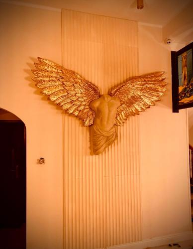 a statue of an eagle on a wall at Hotel Pałac w Myślęcinku in Bydgoszcz