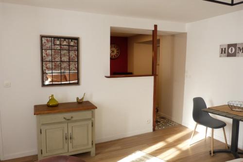 une cuisine avec une table et une chaise ainsi qu'une fenêtre dans l'établissement le nid cosy, à Bayeux