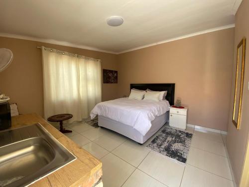 a bedroom with a bed and a bath tub at Inecia's B & B in Uis