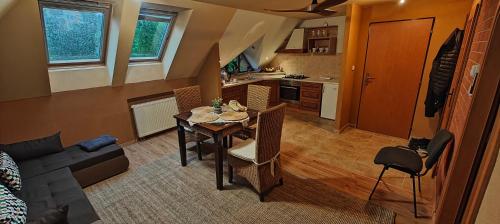 a kitchen and living room with a table and a couch at Parrot district apartments in Nové Zámky