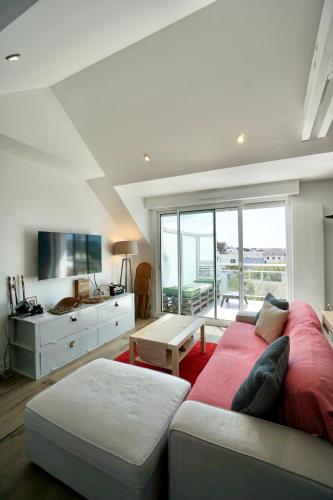 un grand salon avec un canapé et une télévision dans l'établissement Ollie Blue-50m de la plage, à Ploemeur