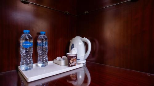 two bottles of water on a shelf in a bathroom at The Villa 604 Powered by look in Cairo