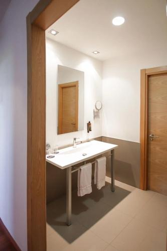 a bathroom with a sink and a mirror at Ohtels Mazagon in Mazagón