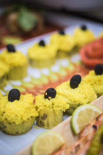a group of cupcakes with black olives and lime slices at Aparthotel Esquinzo Y Monte Del Mar in Playa Jandia