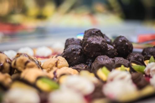 a pile of chocolate covered donuts on a plate at Aparthotel Esquinzo Y Monte Del Mar in Playa Jandia