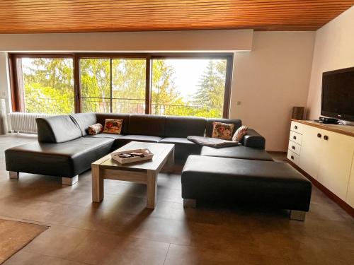 a living room with a couch and a table at Landhaus Stetten in Stetten