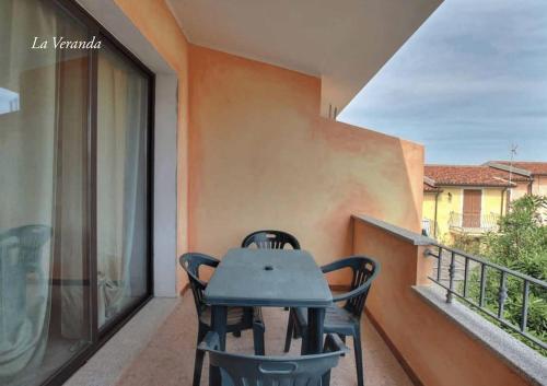 a table and chairs on the balcony of a house at La Ciaccia - appartement vue mer in La Ciaccia