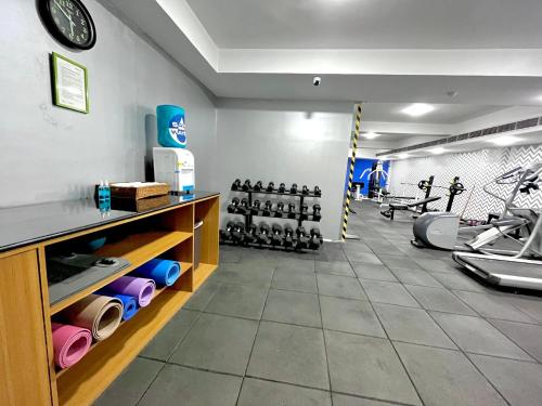 a room with a gym with dumbbells and a gym at Greenpark Hyderabad in Hyderabad