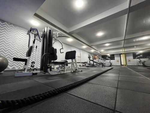 a gym with treadmills and machines in a room at Greenpark Hyderabad in Hyderabad