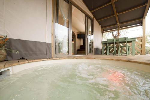 a jacuzzi tub in the middle of a house at Le Lenze Don Mimì Glamping in Mattinata