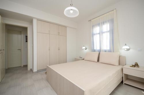Ένα ή περισσότερα κρεβάτια σε δωμάτιο στο Natura Villas in Naxos