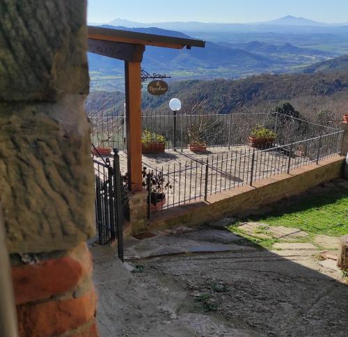 a fence with potted plants on top of a mountain at il Roncolino in Santa Cristina