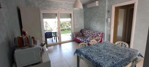 a room with a table and a chair and a window at OLTRE CONFINE fronte mare in Marina di Montenero