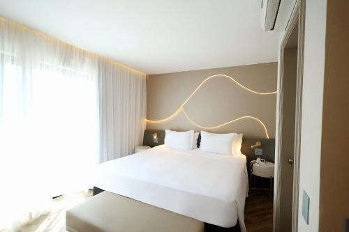 a hotel room with a bed and a window at Radisson Oscar Freire in Sao Paulo