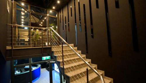 a staircase in a building with lights on it at TIBET HOTEL am Airport Düsseldorf-Ratingen in Ratingen