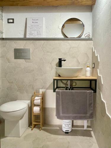 a bathroom with a sink and a toilet at Casa Asproni in Tonara
