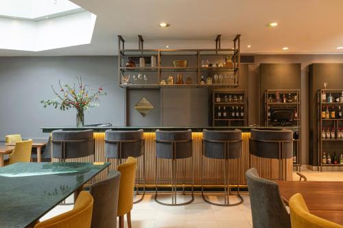 a bar in a restaurant with stools at Argenta Tower Hotel & Suites in Buenos Aires