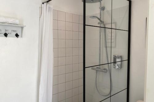 a shower with a glass door in a bathroom at Harbour View in Sønderborg