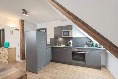 a kitchen with stainless steel appliances in a attic at Ferienquartier Forsthaus 2 in Bad Gottleuba