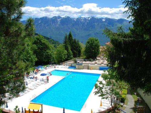 an overhead view of a swimming pool with mountains in the background at La Bella Garda in Tignale