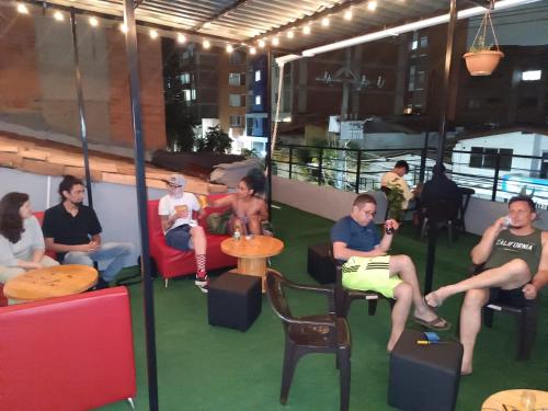 a group of people sitting in chairs in a room at Absolute Hotel & Hostel Boutique in Medellín