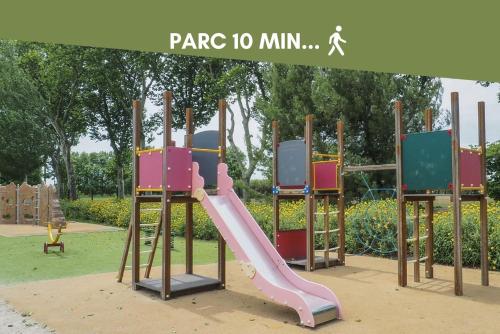 a playground with a slide in a park at NOUVEAU Jungle Village WIFI Netflix Clim in Mauguio