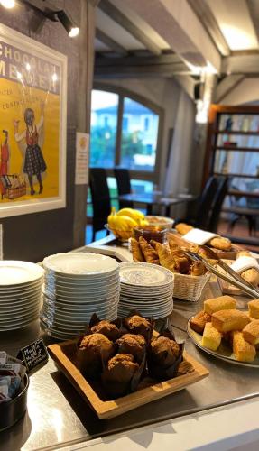 a table with plates of food on top at Logis Hôtel Médiéval, Montélimar Nord in Rochemaure