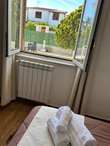 a bedroom with a bed and a window with a view at B&B Villa Achibea in Agrigento
