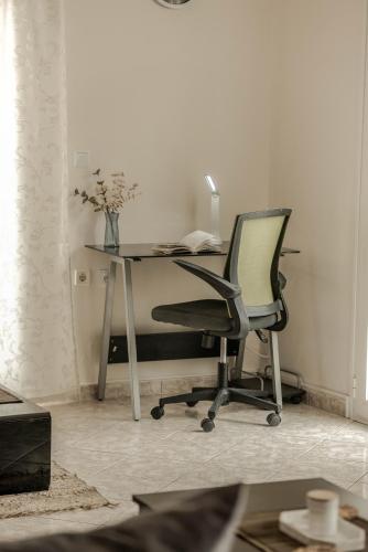 an office with a desk with a chair and a lamp at Nitsa's Corner in Zakynthos Town